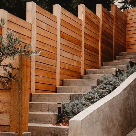 Wooden privacy fence alongside a landscaped staircase.