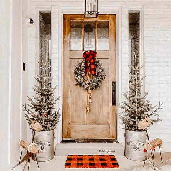 You can see a front porch decorated in a farmhouse look.