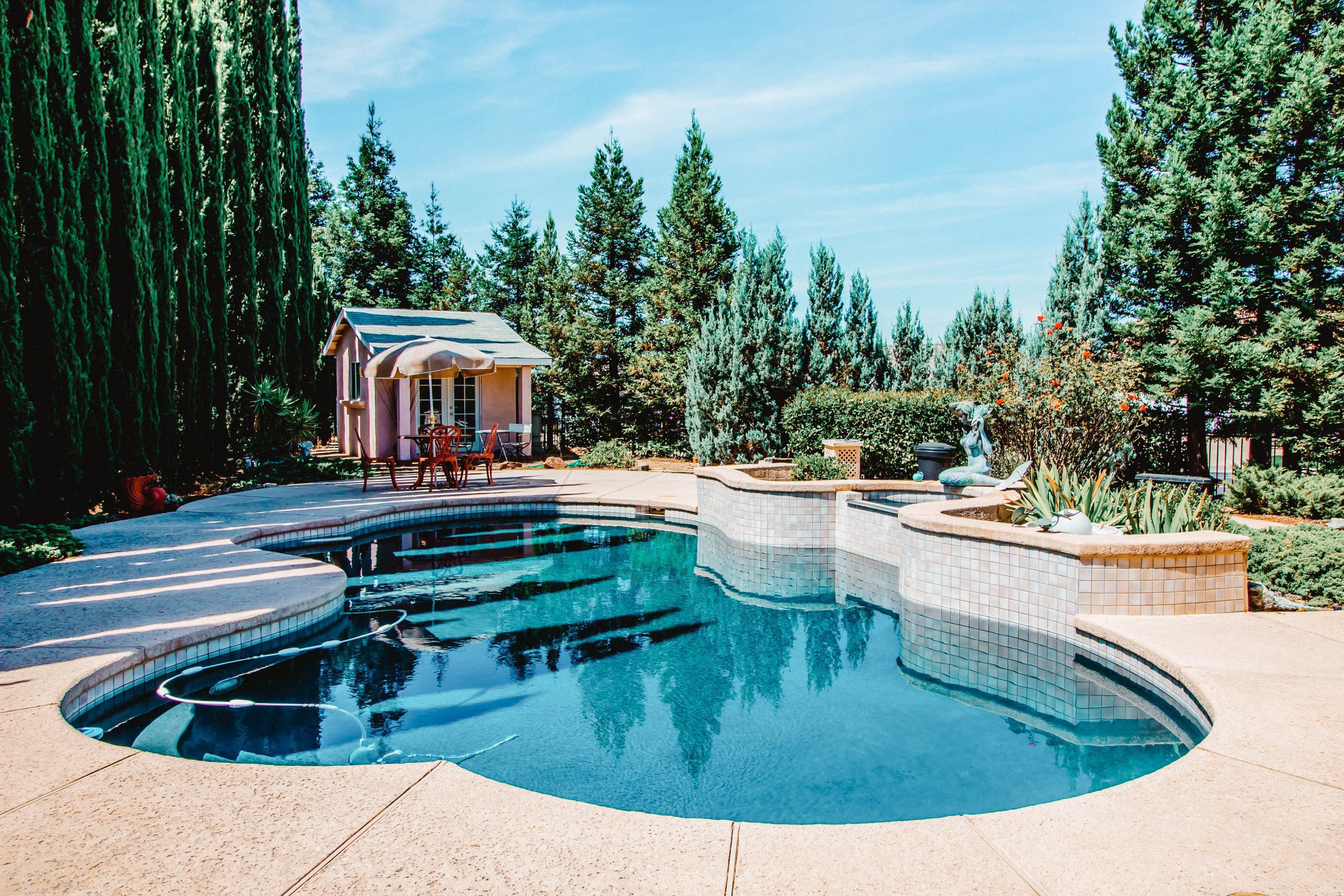 A pool house near a pool.