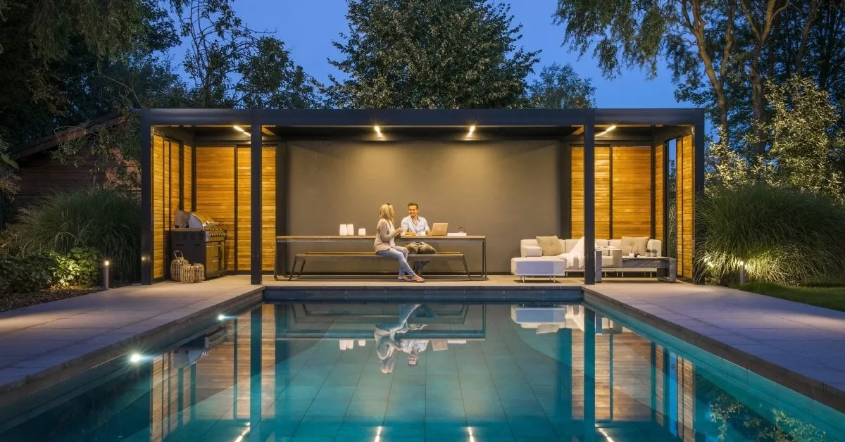 Modern pool house with a seating area, supported by screw pile foundations.