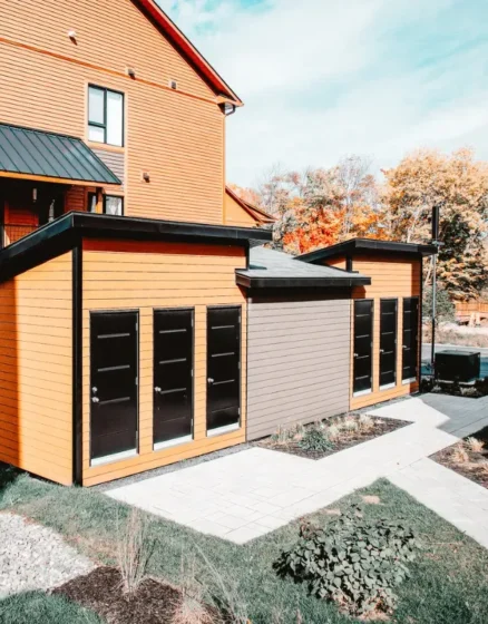 Two modern sheds with sturdy foundations, supported by screw piles, providing long-lasting stability for garden structures.